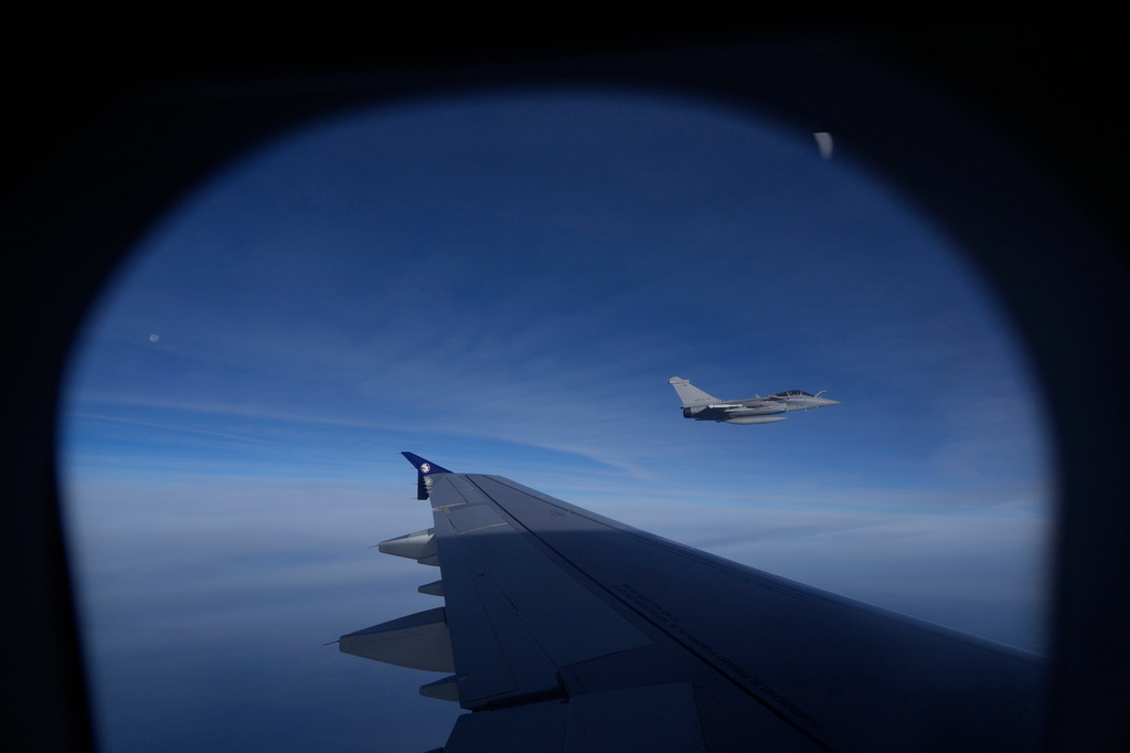 A French Air Force Dassault Rafale C fighter jet is seen through a window of the aircraft carrying Pope Leo XIV from Lourdes to Metz on the last day of his four-day visit to France, Monday, Sept. 28, 2026. (AP Photo/Gregorio Borgia, Pool)