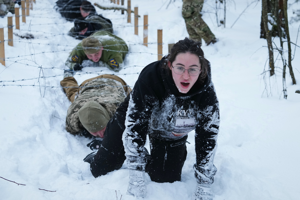 Participants of the tactical and medical courses run by the 3rd Assault Brigade demonstrate their skills in a final exam for civilians in Kyiv regional center for preparing the population for national resistance, Ukraine, Sunday, Feb. 8, 2026. (AP Photo/Sergei Grits)
