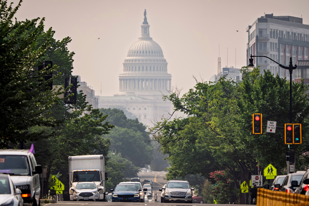 The U.S. Capitol is seen from a street in Washington as heavy smoke from wildfires shrouds the atmosphere, Friday, July 17, 2026. (AP Photo/J. Scott Applewhite)