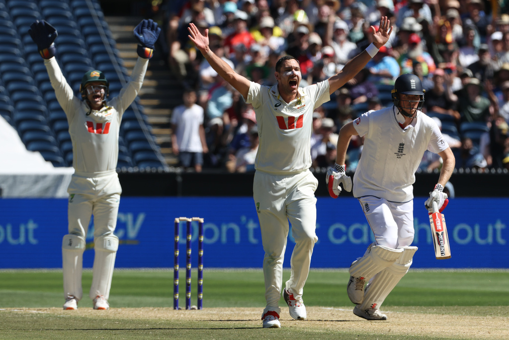Australia's Scott Boland, center, successfully appeals for a LBW decision on England's Zak Crawley, right, on Day 2 of their Ashes cricket test match in Melbourne, Saturday, Dec. 27, 2025. (AP Photo/Hamish Blair)