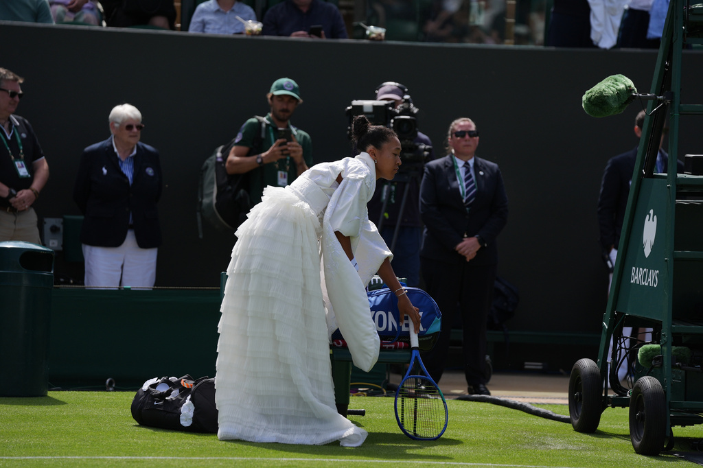 Naomi Osaka of Japan walks into the court to play against Elsa Jacquemot of France in their first round women's singles match at the Wimbledon Tennis Championships in London, Monday, June 29, 2026. (AP Photo/Maja Smiejkowska)