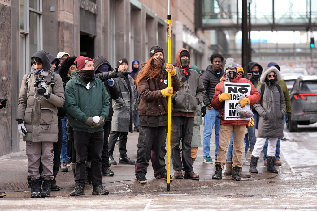 Pro-immigration protesters stand on the sideway Saturday, Jan. 17, 2026, in Minneapolis. (AP Photo/Yuki Iwamura)