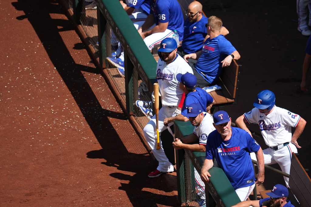 Texas Rangers manager Bruce Bochy, bottom, looks on from the dugout during the fourth inning of a baseball game against the Minnesota Twins Thursday, Sept. 25, 2025, in Arlington. (AP Photo/Julio Cortez)