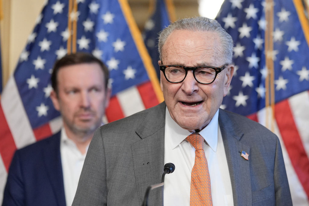 Senate Minority Leader Chuck Schumer, of N.Y., right, speaks as Sen. Chris Murphy, D-Ct., left, listens during a news conference on health insurance premiums on Capitol Hill, Wednesday, Dec. 10, 2025, in Washington. (AP Photo/Mariam Zuhaib)