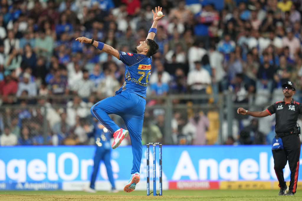 Mumbai Indians' AM Ghazanfar tries to field a ball during the Indian Premier League cricket match between Mumbai Indians and Kolkata Knight Riders in Mumbai, India, Sunday, March 29, 2026. (AP Photo/Rafiq Maqbool)