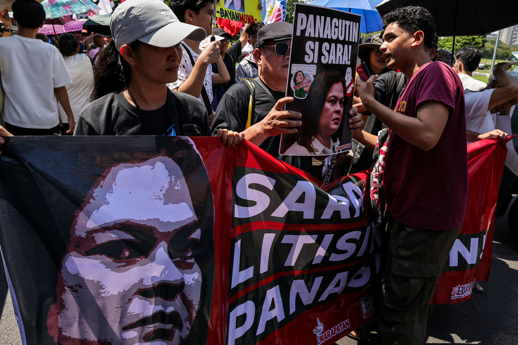 Protesters carry a banner calling for the impeachment of Philippine Vice President Sara Duterte during a protest in front of the Senate in Pasay, Philippines, Monday, July 6, 2026. (AP Photo/Gerard Carreon)