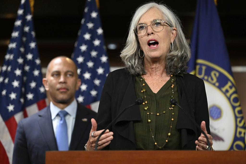 House Minority Leader Hakeem Jeffries, D-N.Y., left, listens to House Minority Whip Katherine Clark, D-Mass., speaks at a news conference on the 8th day of a government shutdown at the U.S. Capitol on Wednesday, Oct. 8, 2025, in Washington. (AP Photo/John McDonnell)