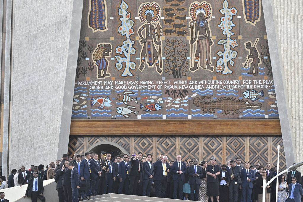 Australian Prime Minister Anthony Albanese, center right, and other dignitaries stand in front of Parliament House after a flag raising ceremony in Port Moresby, Papua New Guinea, Tuesday, Sept. 16, 2025. (Mick Tsikas/AAP Image via AP)