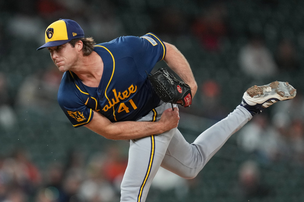Milwaukee Brewers pitcher Jake Woodford throws against the Detroit Tigers during the ninth inning of a baseball game Tuesday, April 21, 2026, in Detroit. (AP Photo/Paul Sancya)