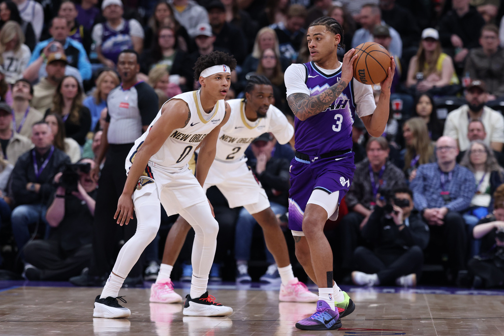 Utah Jazz guard Keyonte George (3) looks for a play as New Orleans Pelicans guard Jeremiah Fears (0) defends during the first half of an NBA basketball game, Saturday, Feb. 28, 2026, in Salt Lake City. (AP Photo/Rob Gray)
