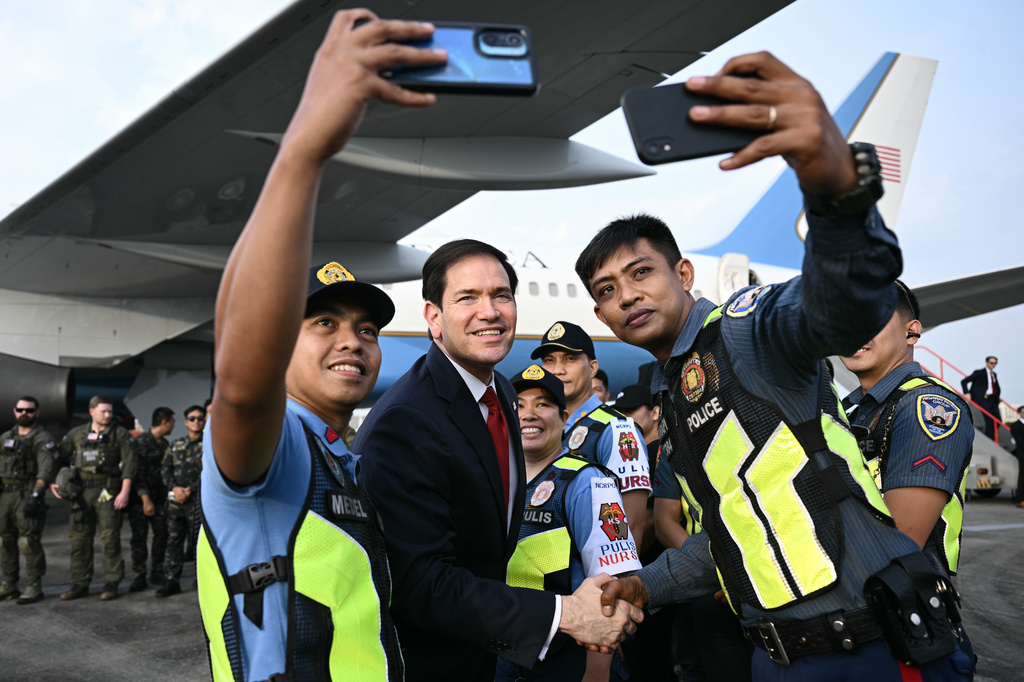 Secretary of State Marco Rubio meets Philippine police and others security personnel before departing from Ninoy Aquino International Airport in Manila, Philippines, following his visit to attend the Association of Southeast Asian Nations (ASEAN) Foreign Ministers Meeting,Thursday, July 23, 2026. (Brendan Smialowski/Pool Photo via AP)