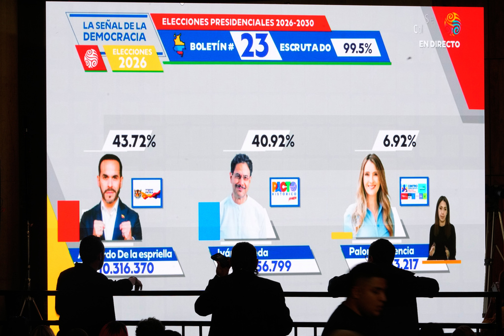Election results showing presidential candidates Abelardo de la Espriella of the Defenders of the Motherland movement and Ivan Cepeda of the ruling Historic Pact coalition advancing to a runoff election are projected at Cepeda's campaign headquarters in Bogota, Colombia, Sunday, May 31, 2026. (AP Photo/Matias Delacroix)