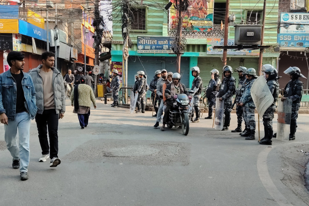 Policemen in riot gear stand guard in Birgunj, 130 kilometers (81miles) south of Katmandu, Nepal, Monday, Jan. 5, 2026. (AP Photo/Jiyalal Sah)