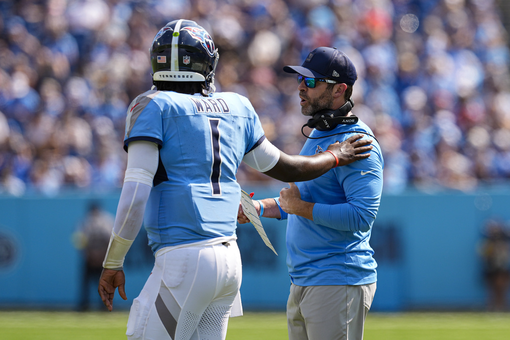 Tennessee Titans head coach Brian Callahan talks with quarterback Cam Ward (1) during the second half of an NFL football game against the Indianapolis Colts Sunday, Sept. 21, 2025, in Nashville, Tenn. (AP Photo/George Walker IV)