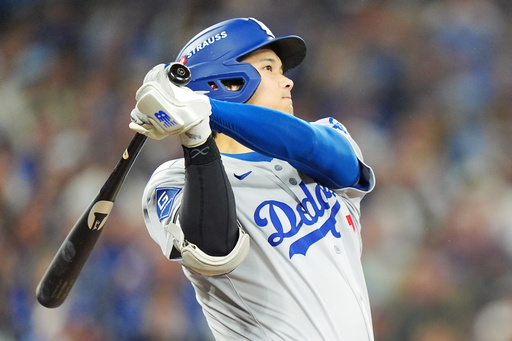 Los Angeles Dodgers' Shohei Ohtani hits a two-run home run against the Toronto Blue Jays during the seventh inning of Game 1 of baseball's World Series in Toronto, Friday, Oct. 24, 2025. (Frank Gunn/The Canadian Press via AP) Los Angeles Dodgers' Shohei Ohtani hits a two-run home run against the Toronto Blue Jays during the seventh inning of Game 1 of baseball's World Series in Toronto, Friday, Oct. 24, 2025. (Frank Gunn/The Canadian Press via AP)