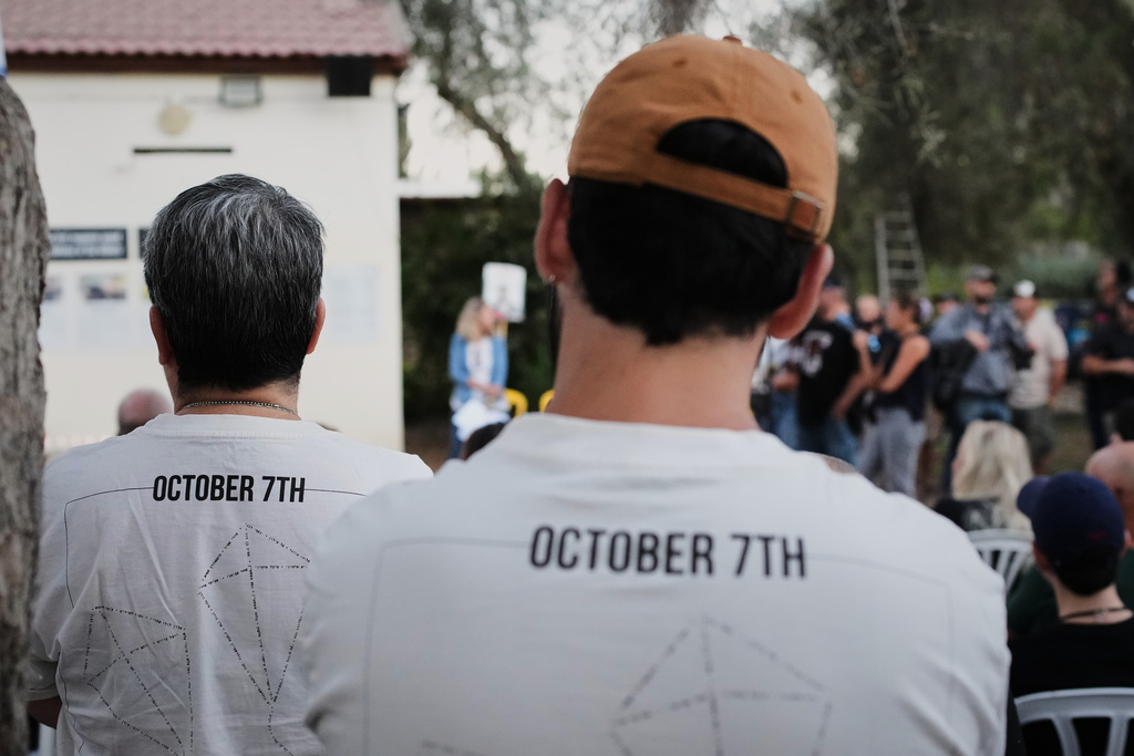 People attend a memorial service marking two years since the Oct. 7, 2023, Hamas cross-border attack on Israel, in Kibbutz Kfar Aza, southern Israel where many of its community members were Killed and abducted, Tuesday, Oct. 7, 2025. (AP Photo/Ohad Zwigenberg)