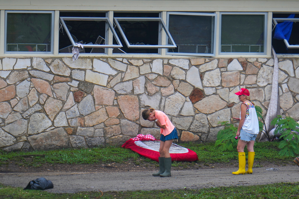 People react as they inspect an area outside sleeping quarters at Camp Mystic along the banks of the Guadalupe River after a flash flood swept through the area, July 6, 2025, in Hunt, Texas. (AP Photo/Julio Cortez, File)