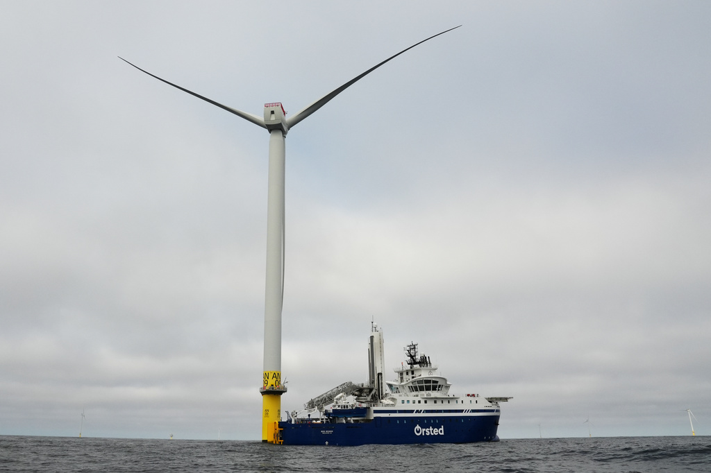 People work on a turbine near an Orsted boat at South Fork Wind offshore wind farm off the coast of Block Island, R.I., Thursday, April 23, 2026. (AP Photo/Joshua A. Bickel)