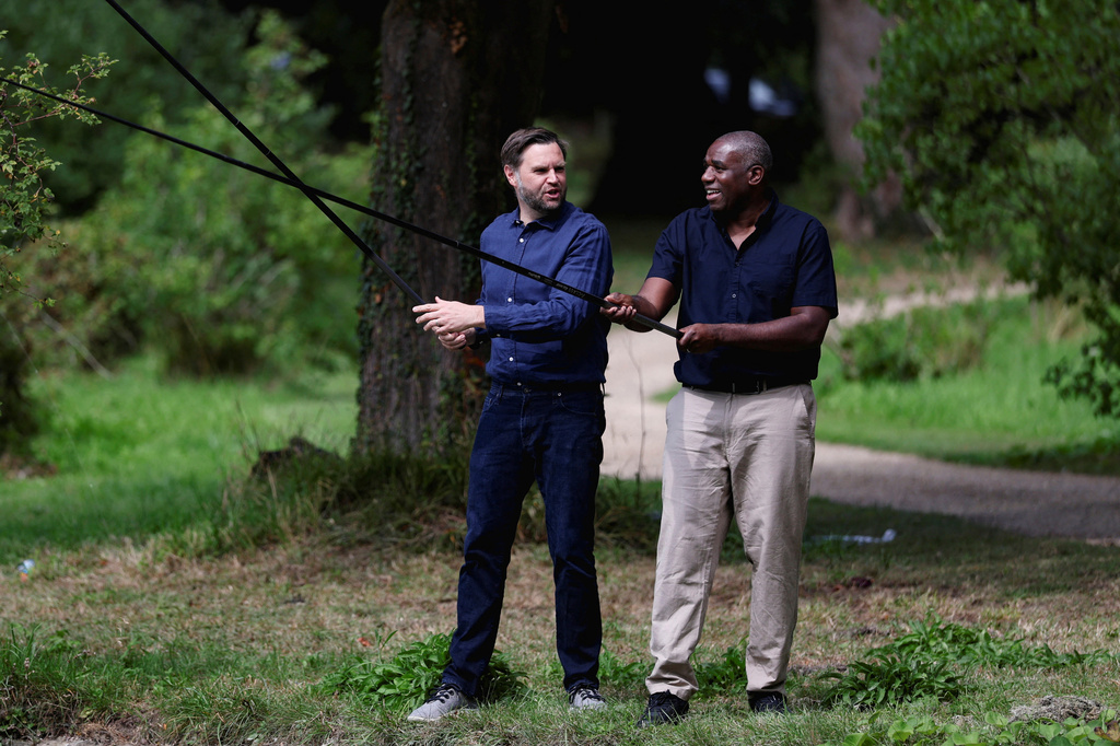 FILE - Britain's Foreign Secretary David Lammy, right, and US Vice President JD Vance fish in a lake in the grounds of Chevening House in Kent, England, Aug. 8, 2025. (Suzanne Plunkett/Pool via AP, File)