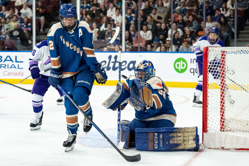 Vancouver Goldeneyes goaltender Emerance Maschmeyer (38) makes a save against the Minnesota Frost as Goldeneyes' Claire Thompson (42) defends during the second period of a PWHL hockey game in Vancouver, British Columbia, Saturday, April 25, 2026. (Ethan Cairns/The Canadian Press via AP)