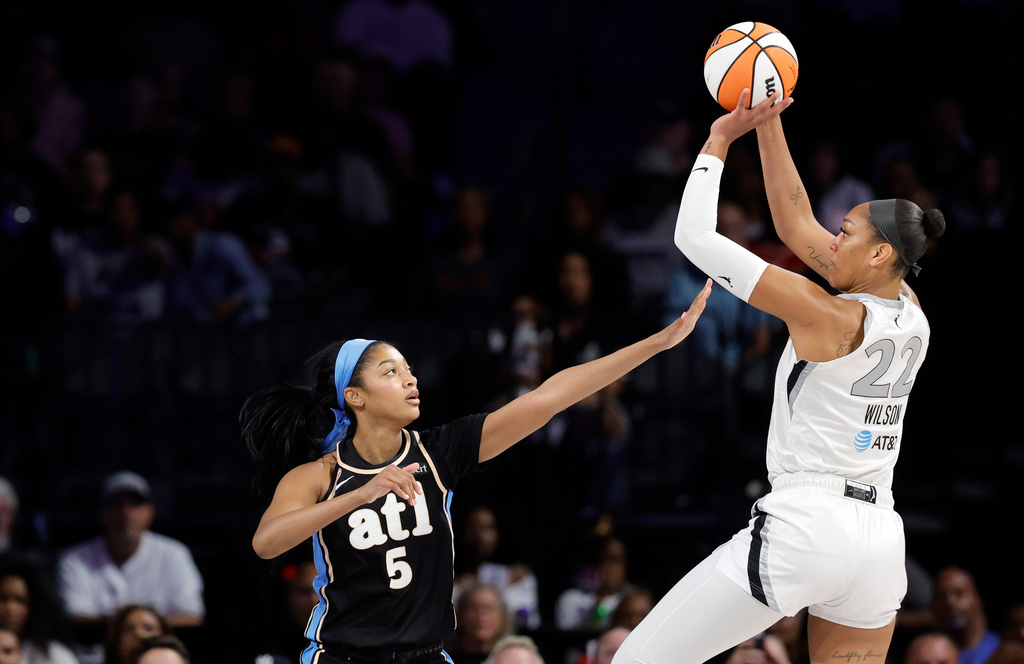Atlanta Dream forward Angel Reese (5) defends against Las Vegas Aces center A'ja Wilson (22) during the first half of a WNBA basketball game Tuesday, Aug. 18, 2026, in Las Vegas. (Steve Marcus/Las Vegas Sun via AP)