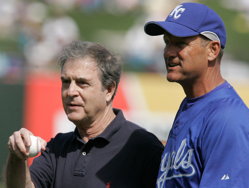 FILE - Hall of Fame members Kansas City Royals broadcaster Denny Matthews, left, and vice-president George Brett are honored before the Cactus League spring training baseball game between the Kansas City Royals and the Texas Rangers in Surprise, Ariz., Sunday, March 4, 2007. (AP Photo/Orlin Wagner, File)