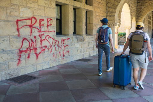 FILE - Students walk by graffiti near university president Richard Saller's office at Stanford University in Stanford, Calif., June 5, 2024. (AP Photo/Nic Coury, File) FILE - Students walk by graffiti near university president Richard Saller's office at Stanford University in Stanford, Calif., June 5, 2024. (AP Photo/Nic Coury, File)