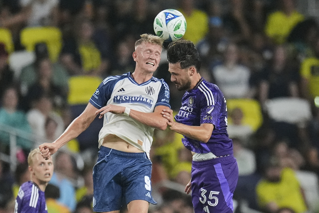 Nashville SC forward Sam Surridge (9) heads the ball over Orlando City midfielder Joran Gerbet (35) during the first half of an MLS soccer match Saturday, Aug. 23, 2025, in Nashville, Tenn. (AP Photo/George Walker IV)