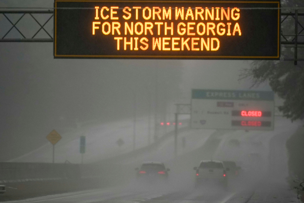 Vehicles move in I-575 during a winter weather event, Sunday, Jan. 25, 2026, in Kennesaw, Ga. (AP Photo/Mike Stewart)