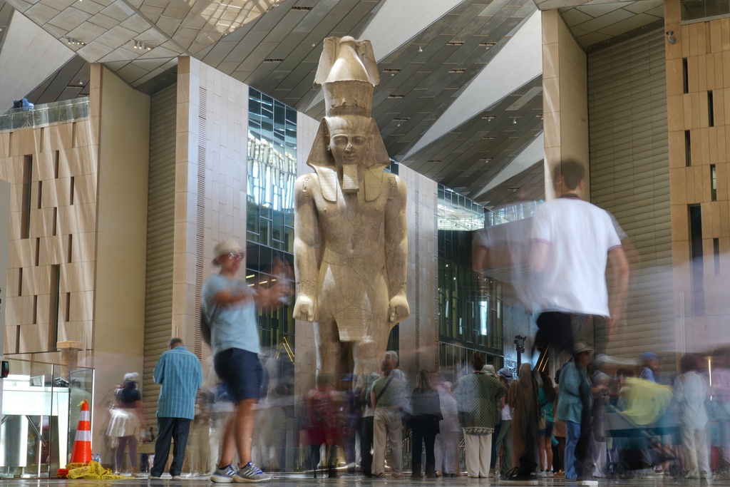 Tourists view the statue of Pharaoh Ramses II, at the Grand Egyptian Museum in Giza, Egypt, Friday, May 23, 2025. (AP Photo/Amr Nabil)