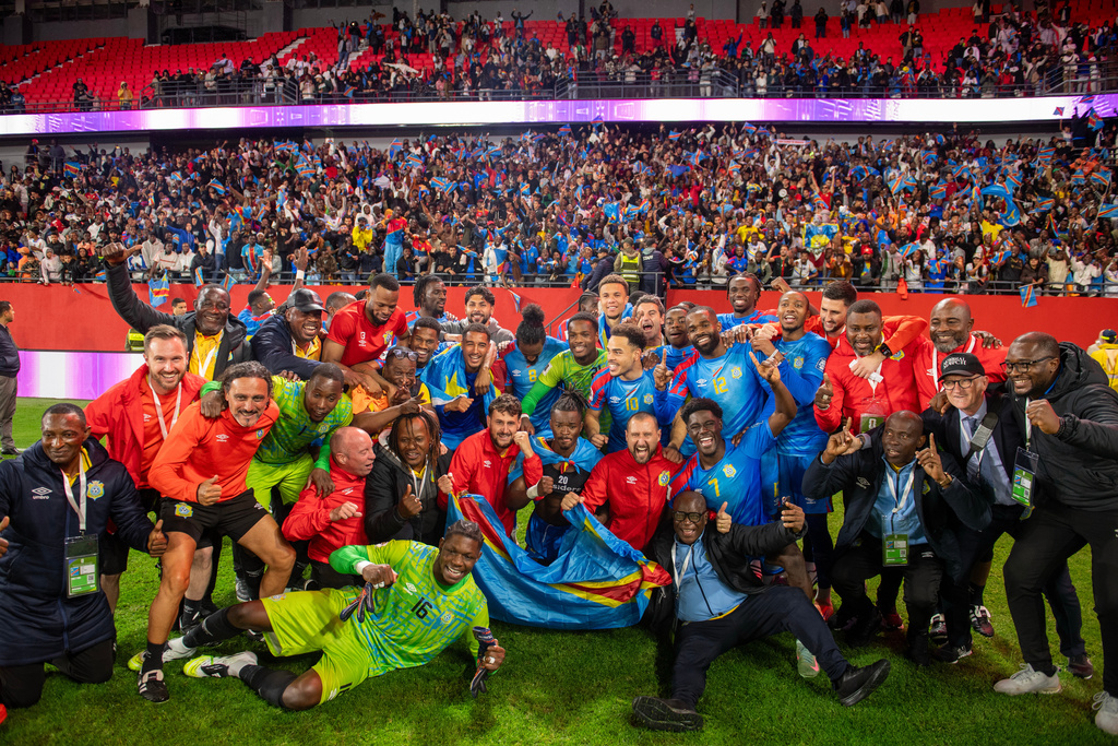 Congo national team members pose for a photo as they celebrate with their coach Sebastien Desabre after being qualified for the FIFA 2026 soccer World Cup in the African qualifier final match against Nigeria, in Rabat, Morocco, Sunday, Nov. 16, 2025. (AP Photo)