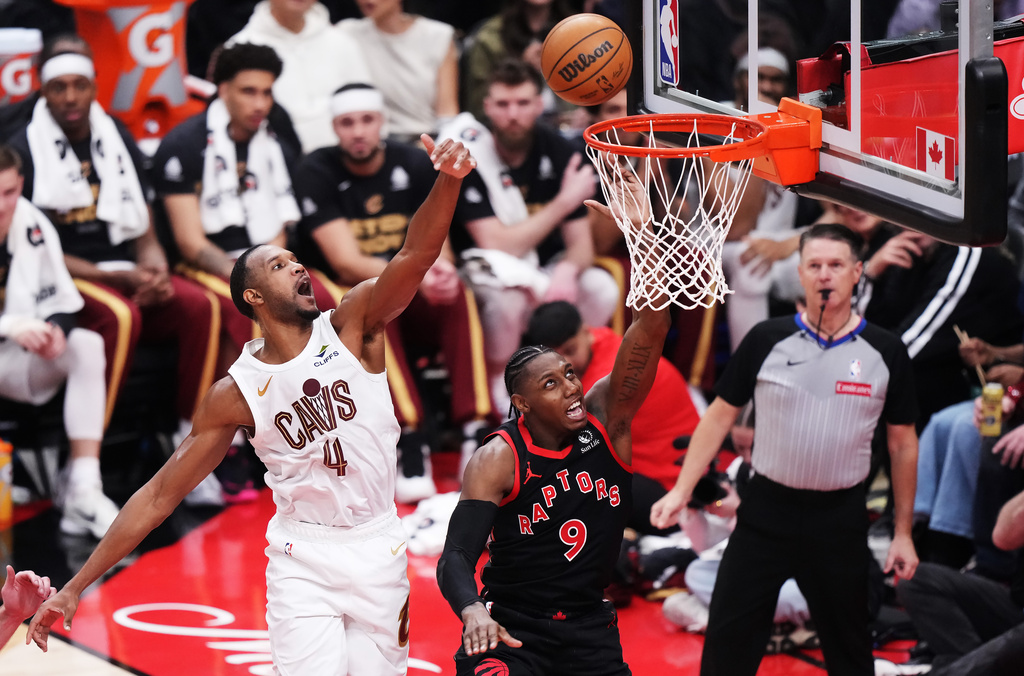 Toronto Raptors' RJ Barrett (9) shoots as Cleveland Cavaliers' Evan Mobley (4) defends during the first half of an NBA basketball playoff game in Toronto on Thursday, April 23, 2026. (Nathan Denette/The Canadian Press via AP)