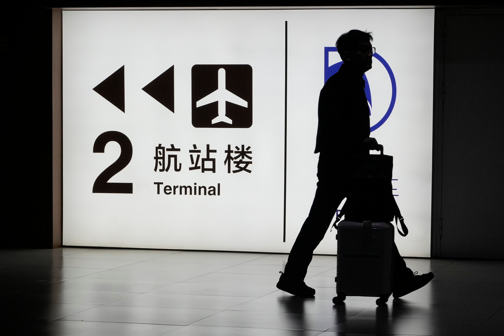 A passenger arrives at the Capital Airport in Beijing on Nov. 7, 2025. (AP Photo/Ng Han Guan)