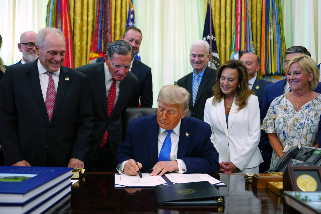 President Donald Trump signs a bill funding immigration enforcement in the Oval Office of the White House, Wednesday, June 10, 2026, in Washington. (AP Photo/Julia Demaree Nikhinson)