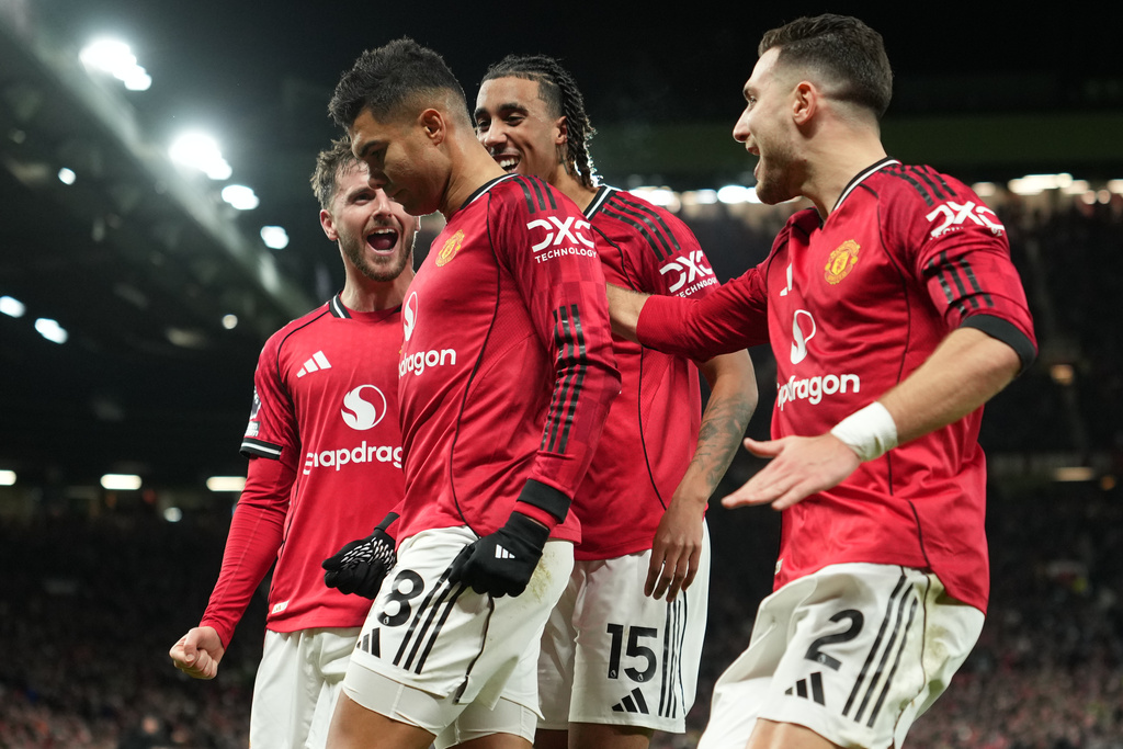 Manchester United players celebrate after a goal during a Premier League soccer match between Manchester United and Bournemouth in Manchester, England, Monday, Dec. 15, 2025. (AP Photo/Jon Super)