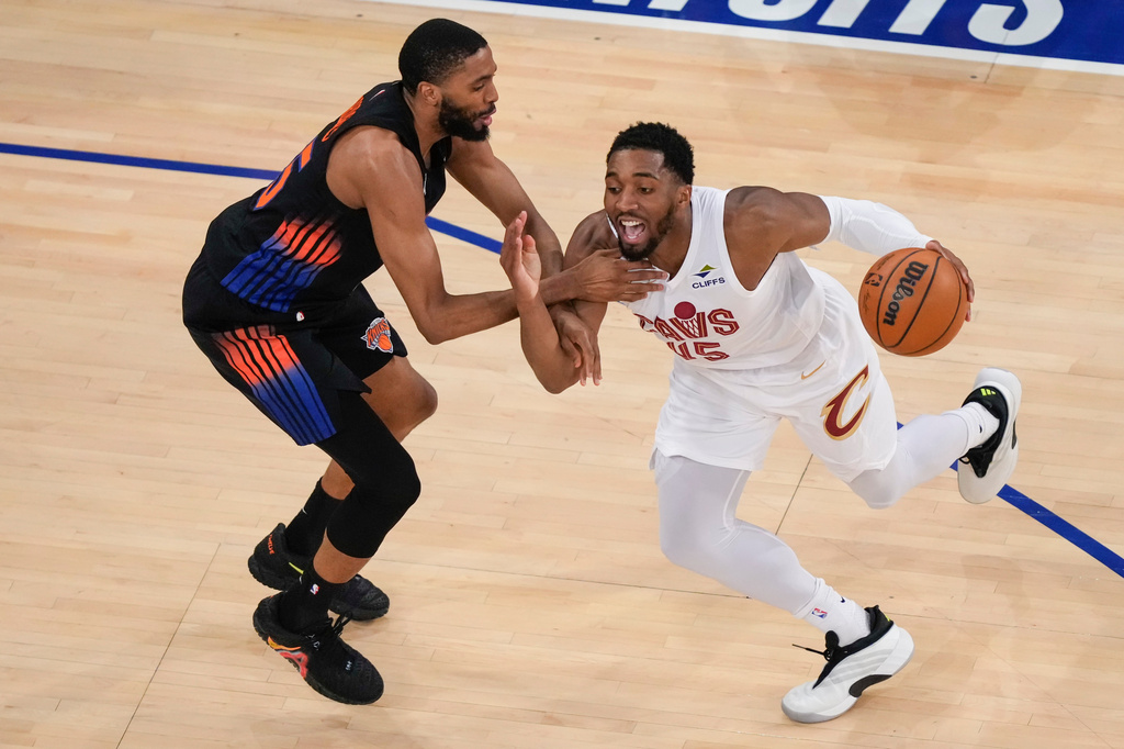 Cleveland Cavaliers guard Donovan Mitchell (45) drives past New York Knicks guard Mikal Bridges (25) during the first half of Game 2 in the Eastern Conference finals NBA basketball playoffs series, Thursday, May 21, 2026, in New York. (AP Photo/Yuki Iwamura)