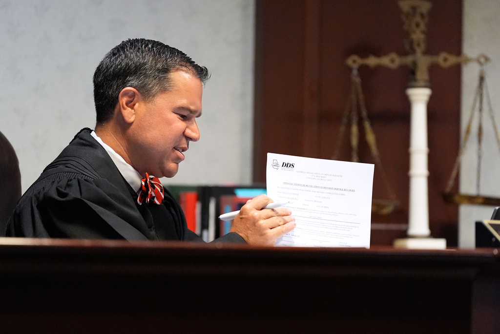 Judge Jason B. Thompson holds up a piece of paper during comedian and actor Tiffany Haddish’s court appearance via Zoom Tuesday, Aug. 11, 2026, in Fayetteville, Ga. (AP Photo/Brynn Anderson)