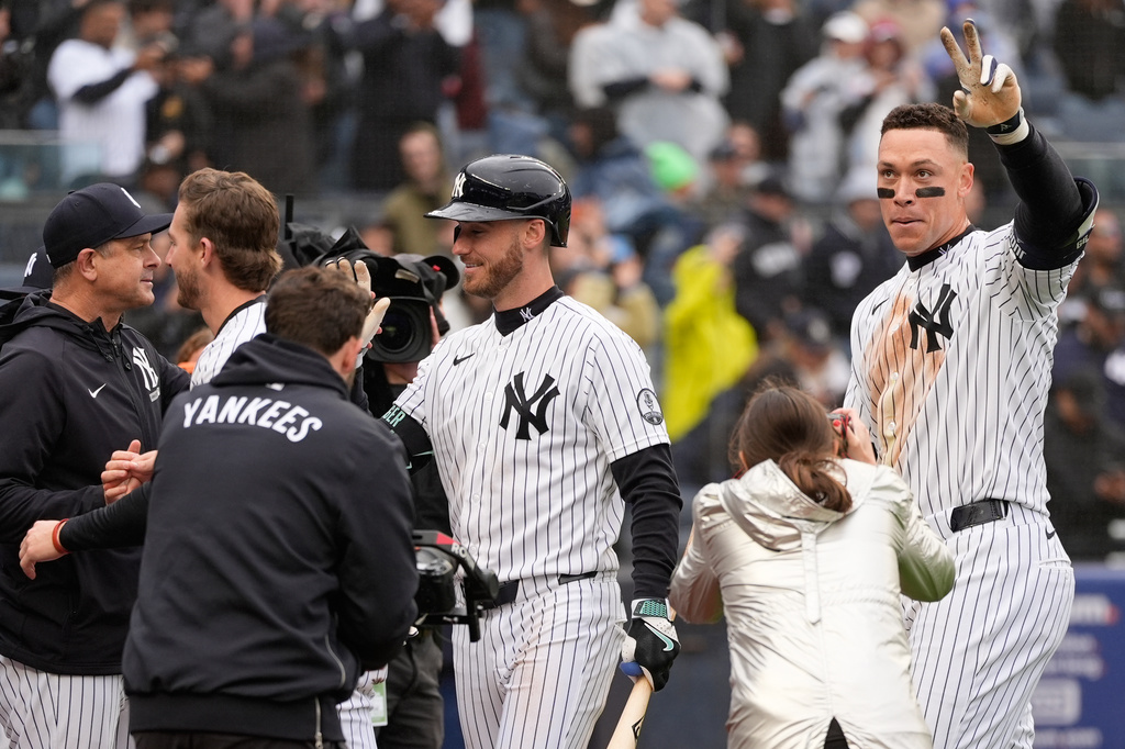 New York Yankees' Aaron Judge, right, reacts after hitting a two-run walk-off home run during the ninth inning of a baseball game against the Tampa Bay Rays, Sunday, May 24, 2026, in New York. (AP Photo/Seth Wenig)