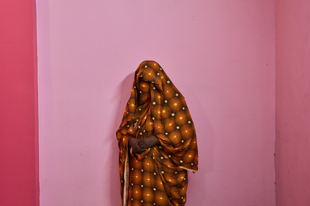 A woman who said she was abducted and sexually assaulted by the Rapid Support Forces, or RSF, before paying a ransom, poses for a portrait after an interview with The Associated Press in Omdurman, on the outskirts of Khartoum, Saturday, April 25, 2026. (AP Photo/Bernat Armangue)