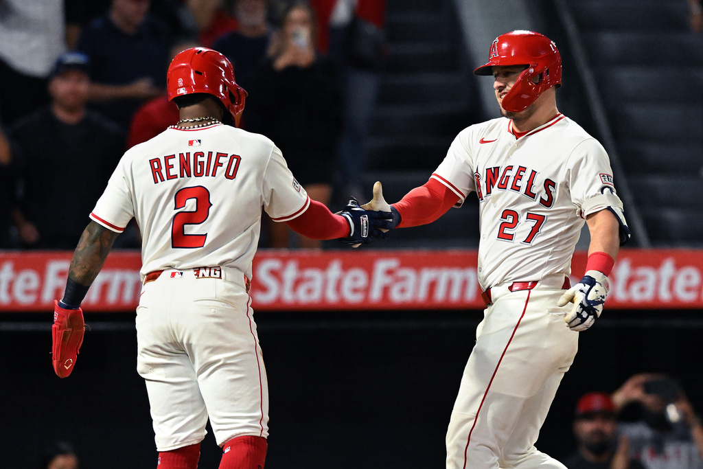 Los Angeles Angels outfielder Mike Trout (27) celebrates his two-run home run with teammate Luis Rengifo (2) against the Kansas City Royals in the eighth inning of a baseball game Thursday, Sept. 25, 2025, in Anaheim, Calif. (AP Photo/Wally Skalij)
