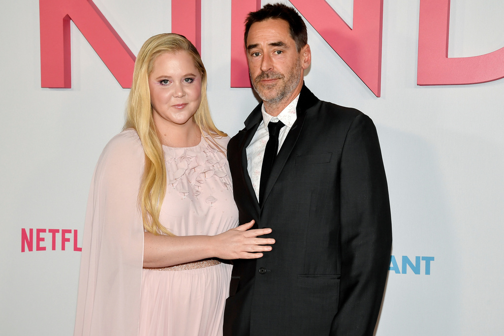 FILE - Amy Schumer and husband Chris Fischer attend the premiere of Netflix's "Kinda Pregnant" at The Plaza Hotel in New York, Feb. 3, 2025. (Photo by Evan Agostini/Invision/AP File)