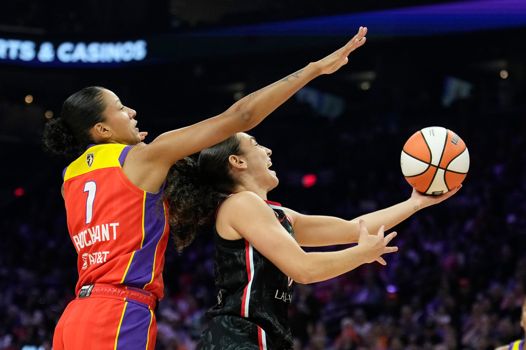 Portland Fire guard Carla Leite, right, drives past Phoenix Mercury forward Noemie Brochant (1) during the first half of a WNBA basketball game Sunday, Aug. 16, 2026, in Phoenix. (AP Photo/Ross D. Franklin)