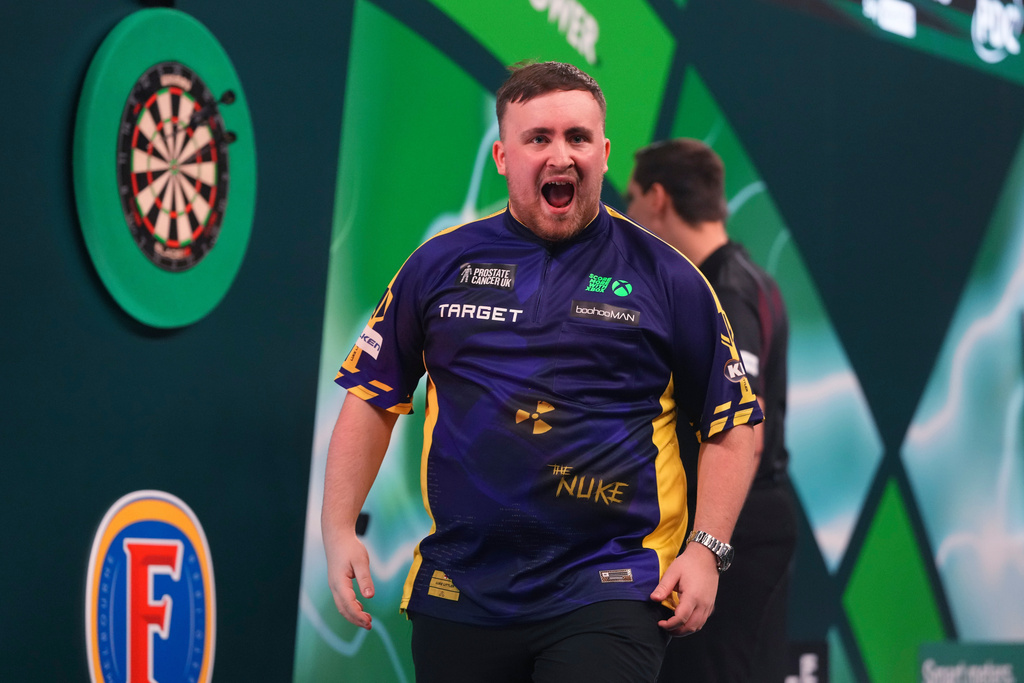 FILE - Luke Littler of England reacts during the semifinal match against Stephen Bunting of England, at the World Darts Championship in London, Jan. 2, 2025. (AP Photo/Kirsty Wigglesworth, File)
