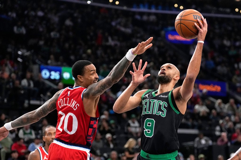 Boston Celtics guard Derrick White, right, shoots as Los Angeles Clippers forward John Collins defends during the first half of an NBA basketball game Saturday, Jan. 3, 2026, in Inglewood, Calif. (AP Photo/Mark J. Terrill)