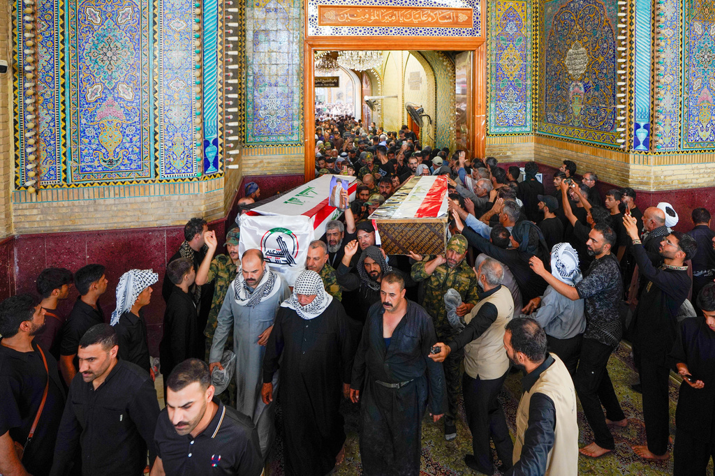 Mourners carry the coffins of Popular Mobilization Forces fighters during their funeral at the Imam Ali Shrine in Najaf, Iraq, Thursday, July 30, 2026, after they were killed in airstrikes on PMF bases. (AP Photo/Anmar Khalil)