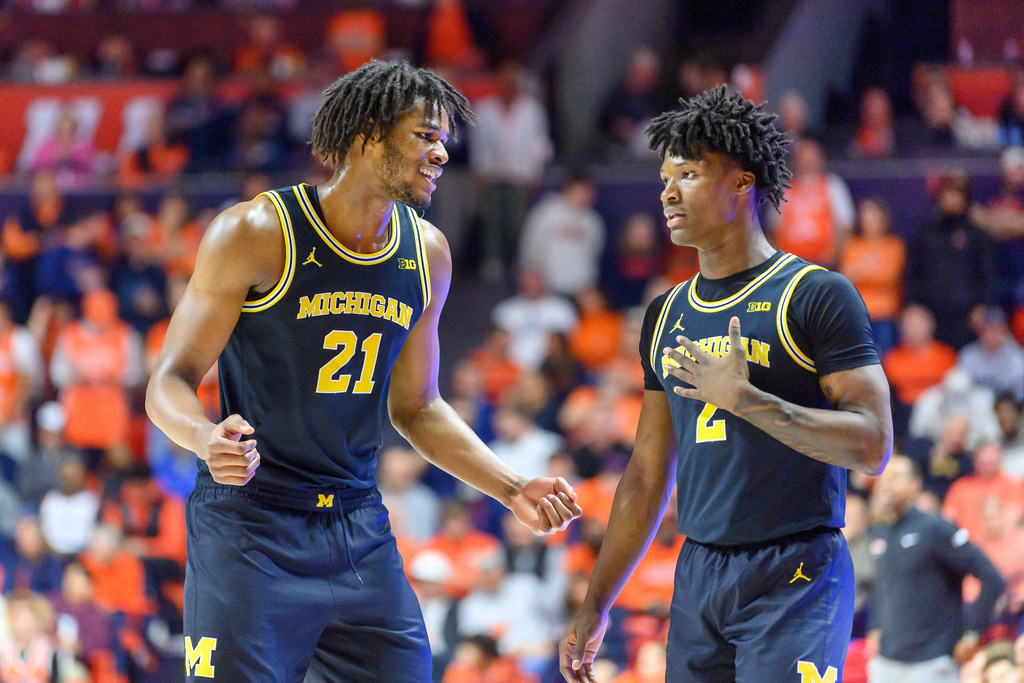 Michigan's Morez Johnson Jr. (21) and L.J. Cason (2) react during an NCAA college basketball game against Illinois, Friday, Feb. 27, 2026, in Champaign, Ill. (AP Photo/Craig Pessman)