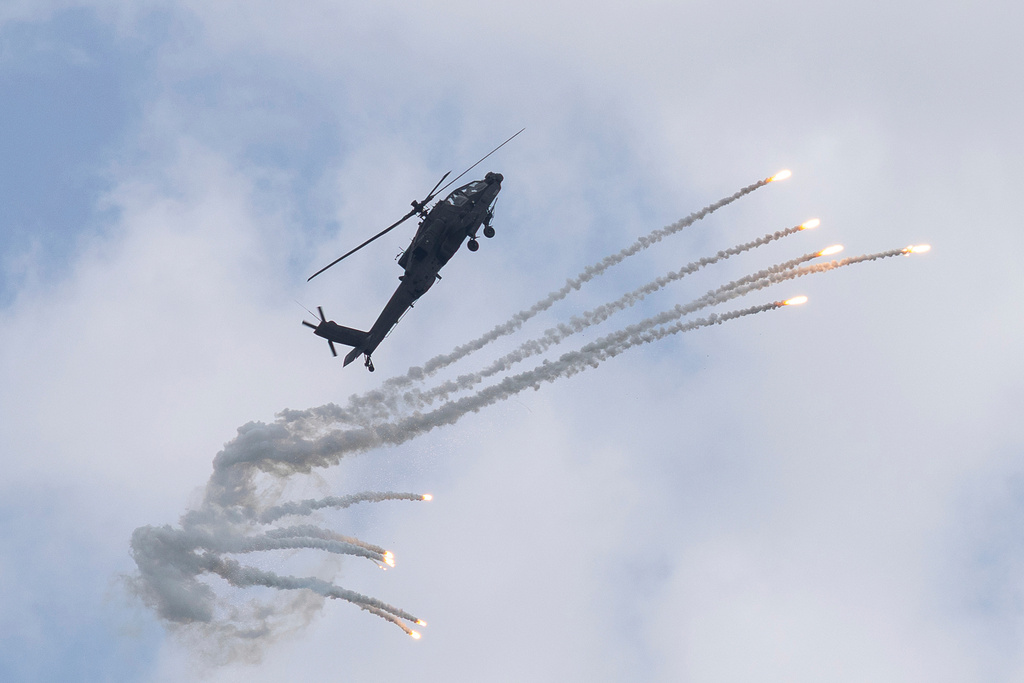 A Singapore Armed Forces military helicopter launches flares during an air display at the Singapore Air Show on Thursday, Feb. 5, 2026. (AP Photo/Anton L. Delgado)