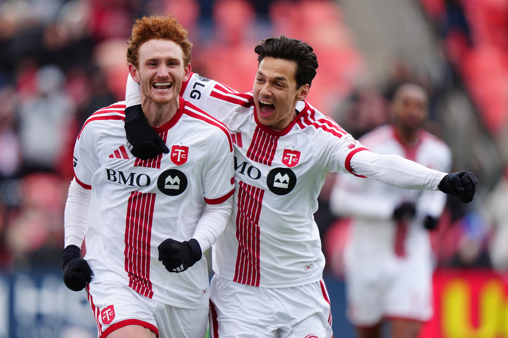 Toronto FC forward Josh Sargent, left, celebrates with Daniel Salloi after scoring a goal agians the Colorado Rapids during the second half of an MLS soccer game in Toronto, Saturday, April 4, 2026. (Frank Gunn/The Canadian Press via AP) CORRECTION: Player at right is Daniel Salloi, not Richie Laryea