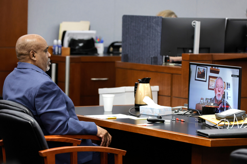 Duane Davis listens as Brent Becker, a retired Las Vegas Metro Police Department homicide detective, testifies by video feed during his murder trial, related to the 1996 killing of rapper Tupac Shakur, at Clark County District Court Regional Justice Center, Monday, Aug. 17, 2026, in Las Vegas. (Steve Marcus/Pool Photo via AP)