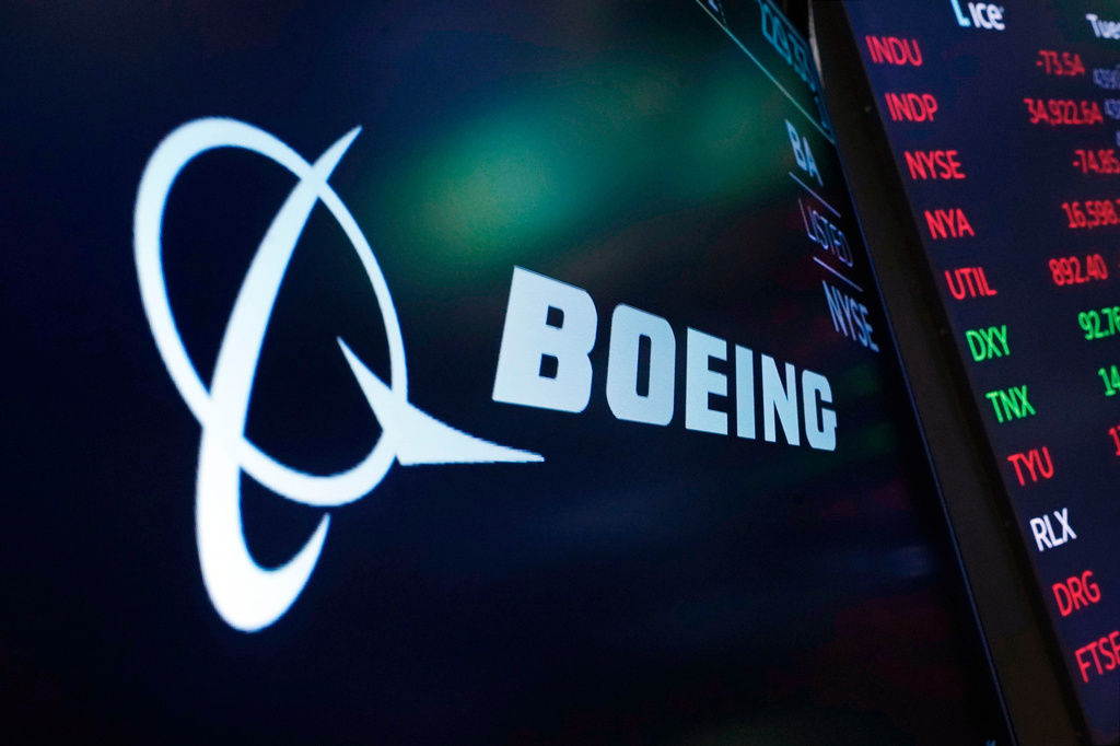 FILE - The logo for Boeing appears on a screen above a trading post on the floor of the New York Stock Exchange, July 13, 2021. (AP Photo/Richard Drew, File)